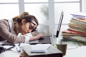 tired woman asleep at her desk due to poor sleep quality from sleep apnea