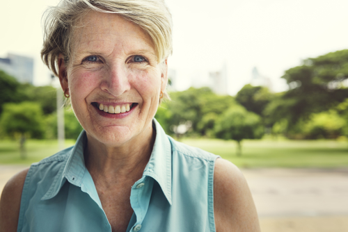 older woman smiling showing healthy teeth thanks to preventive dentistry