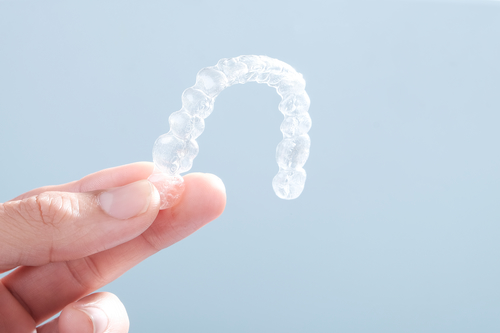 Holding up Invisible aligners plastic braces