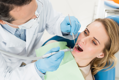 woman getting her teeth checked by a dentist