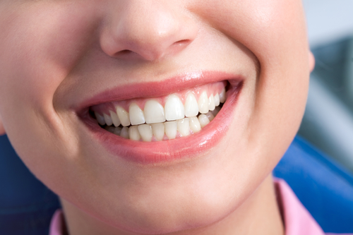 Close-up of happy female showing her healthy teeth in smile