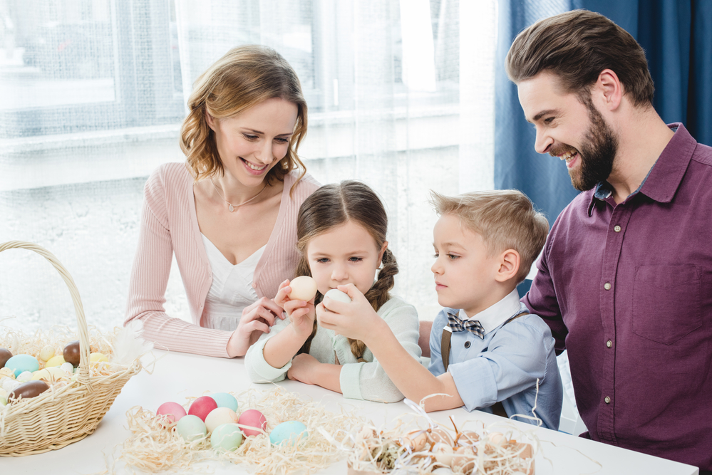 family making easter eggs