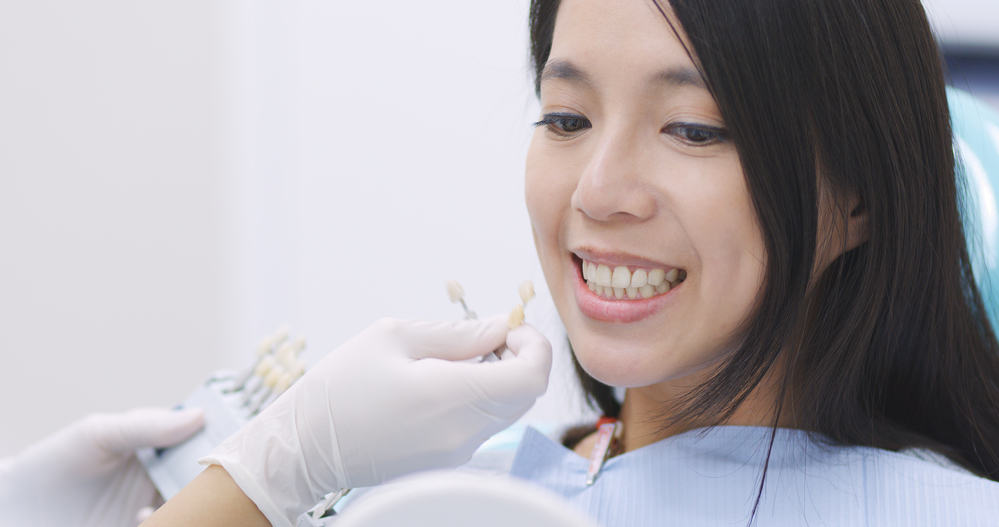 comparing patient's color of teeth