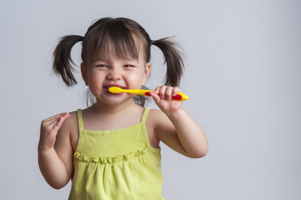 little girl brushing her teeth