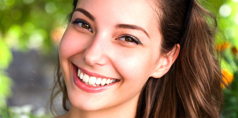 happy young woman smiling showing white teeth