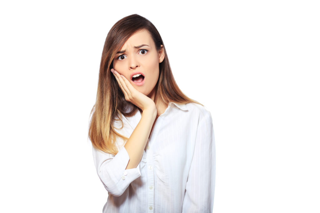 Woman holding her mouth concerned about dental disease.