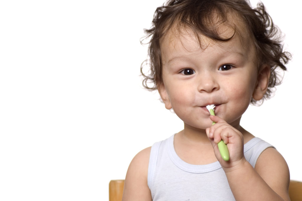 One year old baby brushing teeth. 