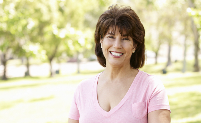 middle aged woman smiling in park