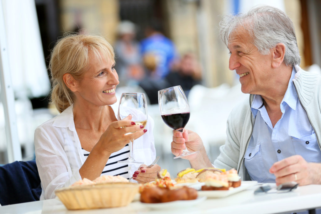 Senior couple enjoying dinner with dentures.