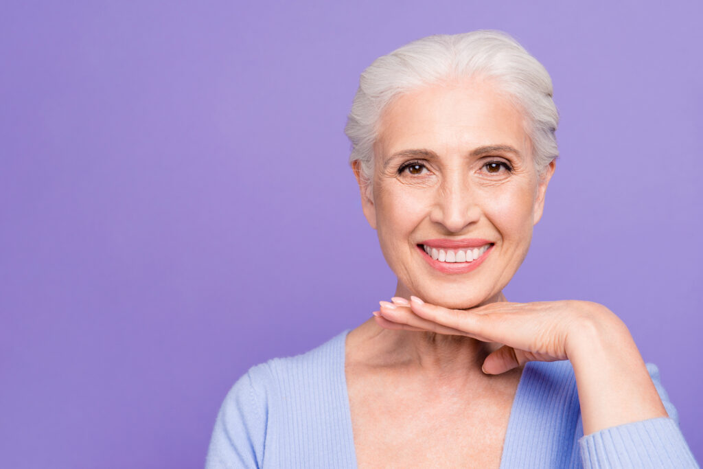 Senior woman showing health teeth. 