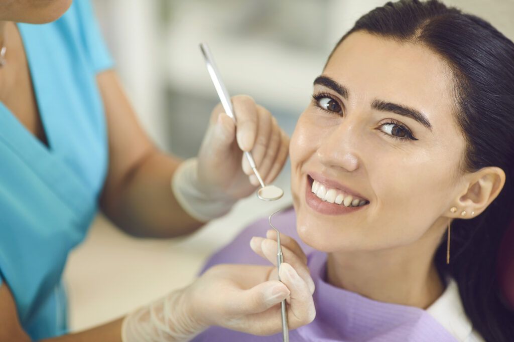 Young woman getting dental treatment. 