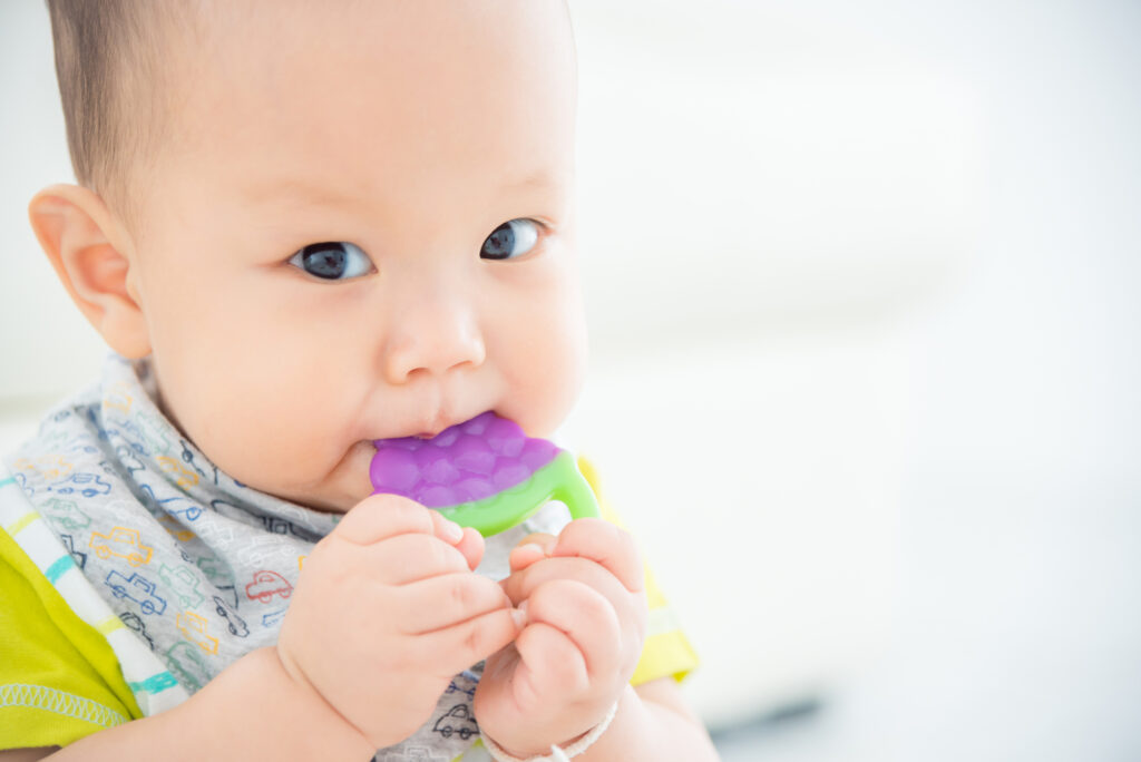 Baby with teething toy.